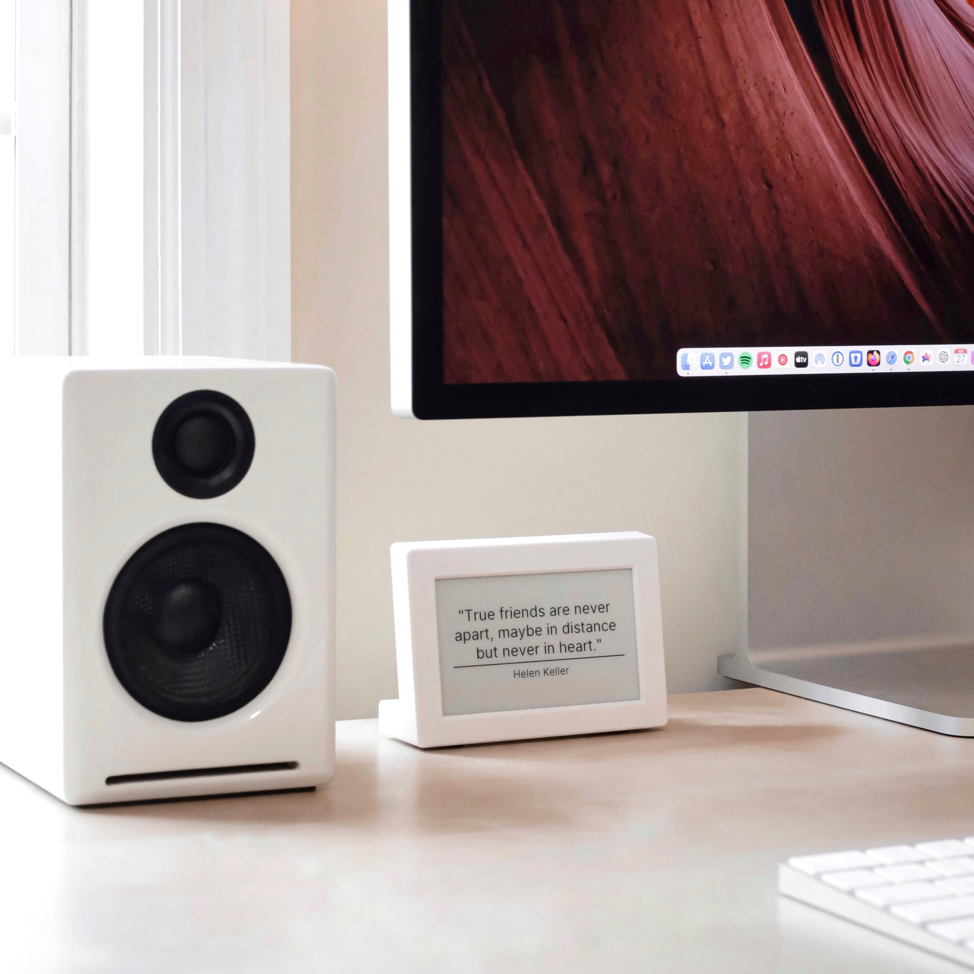 Verba quote display device on a desk next to a speaker and monitor